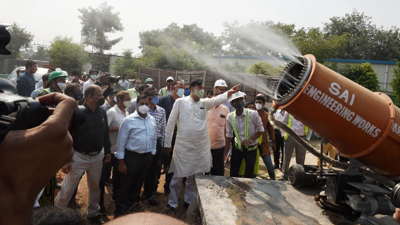 Delhi Environment Minister Gopal Rai inspects an anti smog gun at a construction site, at Pragati Maidan in New Delhi. Credit: PTI.