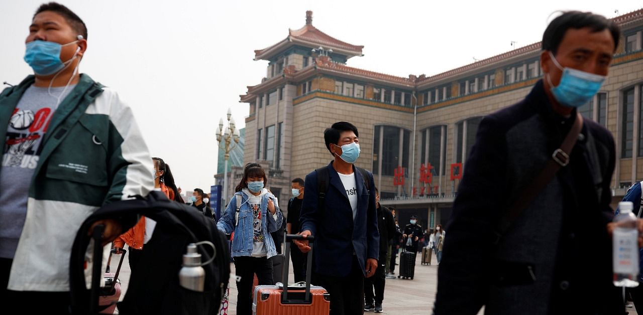 People arrive at Beijing Railway Station after an eight-day National Day holiday following the outbreak of the coronavirus disease in Beijing, China. Credit: Reuters Photo
