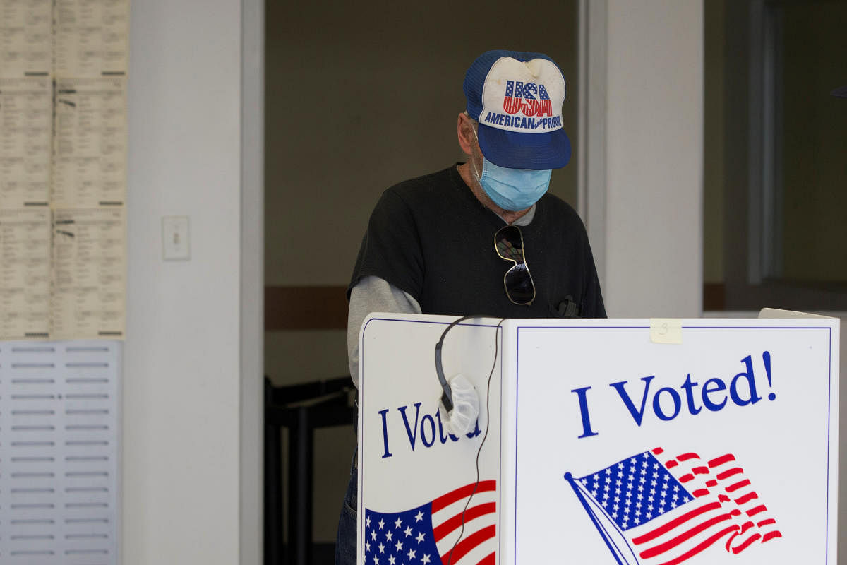 A person casts a ballot for the upcoming presidential election during early voting in Sumter, South Carolina, U.S., October 9, 2020. Credit: Reuters