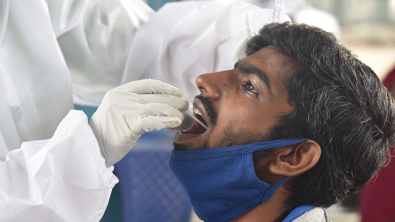 Medical staff collecting nasal swab for Coronavirus test at free checkup. Credits: DH Photo