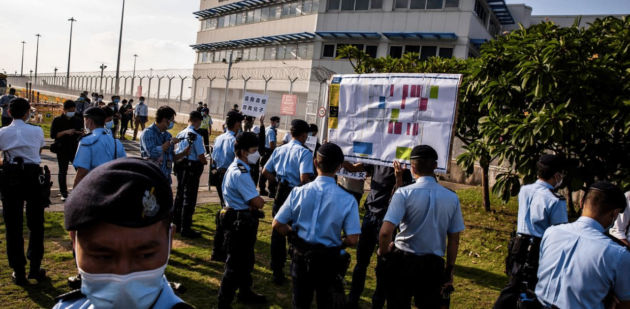 Police break up a protest by family members of 12 Hong Kong residents, who were intercepted by the Chinese coastguard and detained on the mainland in August after they were caught trying to flee Hong Kong for Taiwan on speedboat for serious protest-linked prosecutions, protest outside the Government Flying Service headquarters in Hong Kong. Credit: Reuters Photo 