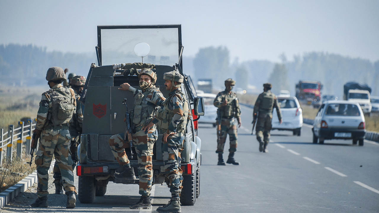 Security forces stand guard during a search operation. Credits: PTI Photo