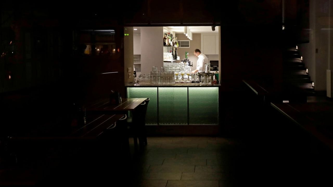 A bartender cleans up a pub, as the Czech government mandated restaurants and pubs to shut by 8:00 p.m. to contain the spread of the new coronavirus disease. Credit: Reuters.