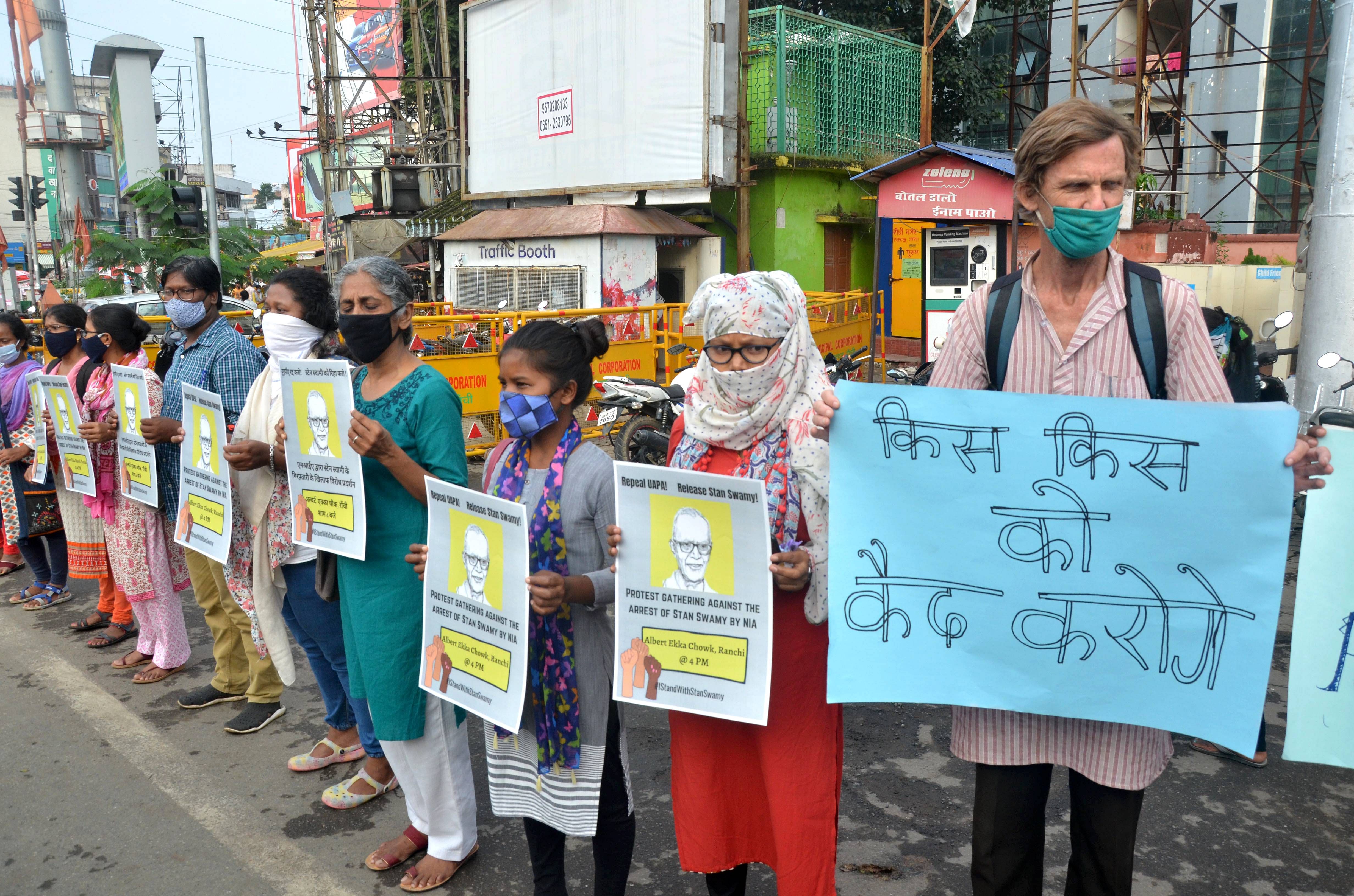 Social activists hold placards during a protest after National Investigation Agency (NIA) arrested 82-year-old Father Stan Swamy on Thursday evening, for his alleged involvement in Bhima Koregaon violence, in Ranchi, Friday, Oct. 9, 2020. Credit: PTI Photo