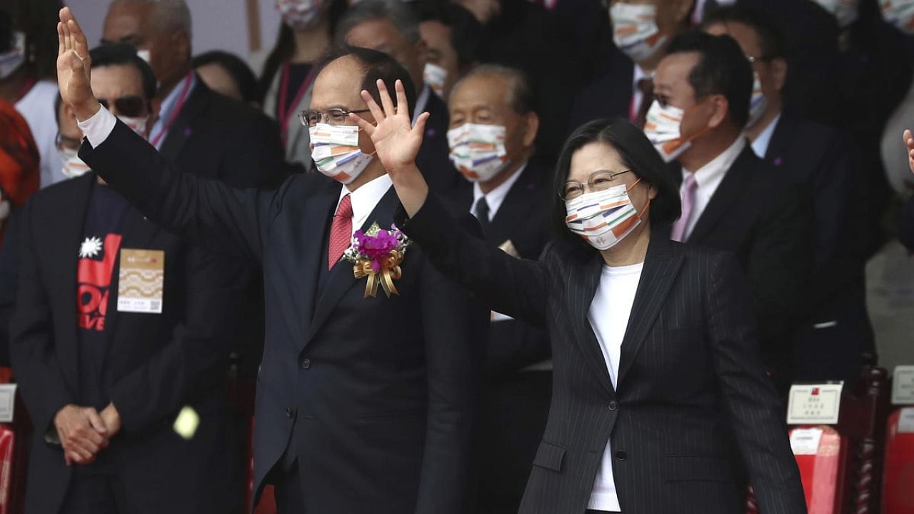 Taiwan's President Tsai Ing-wen, right, and Yu Shyi-kun, speaker of the Legislative Yuan, cheer with audience during National Day celebrations in front of the Presidential Building in Taipei. Credit: AP/PTI.