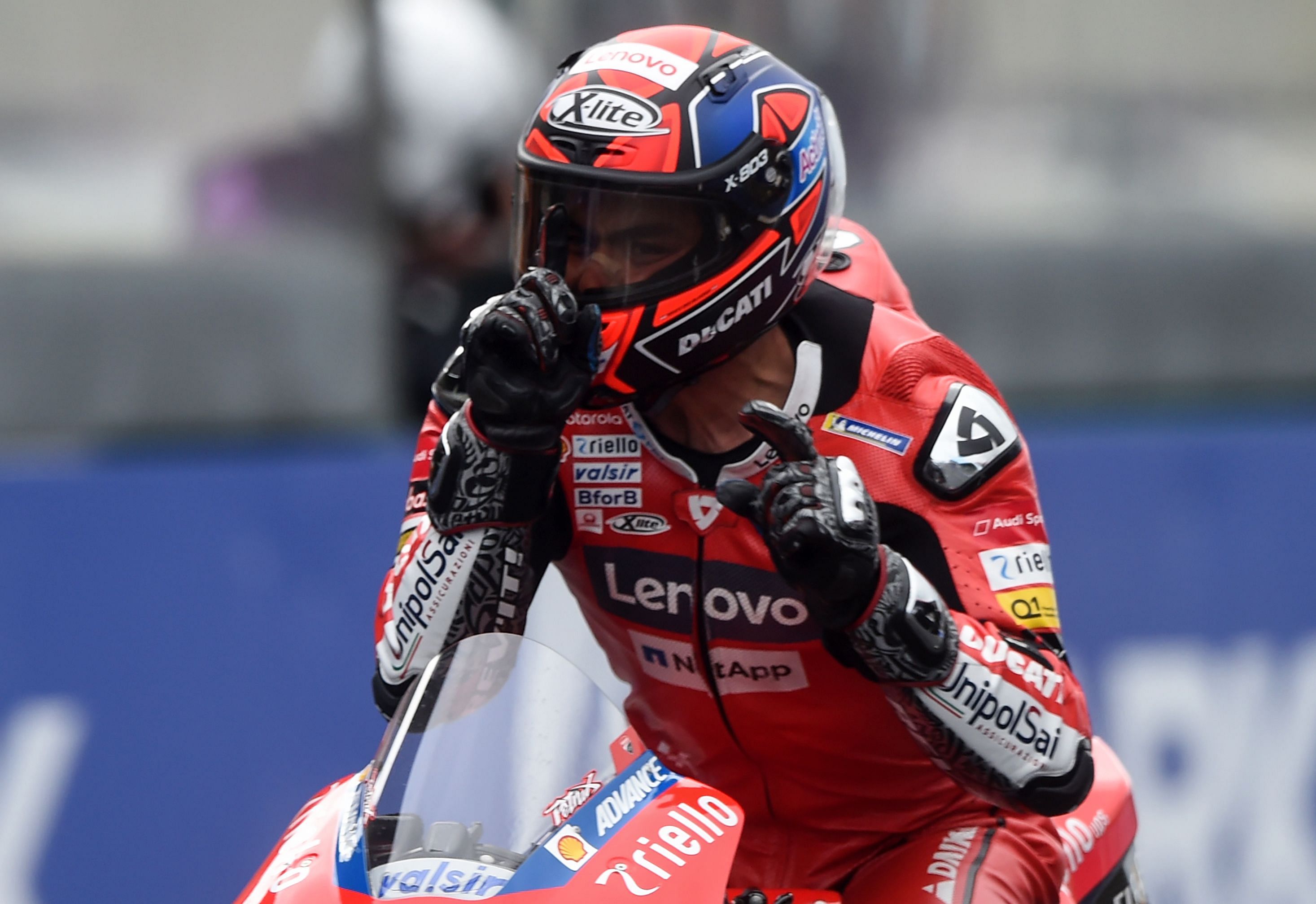 Ducati's Italian rider Danilo Petrucci celebrates as he crosses the finish line to wins in the French MotoGP race in Le Mans. Credits: AFP Photo