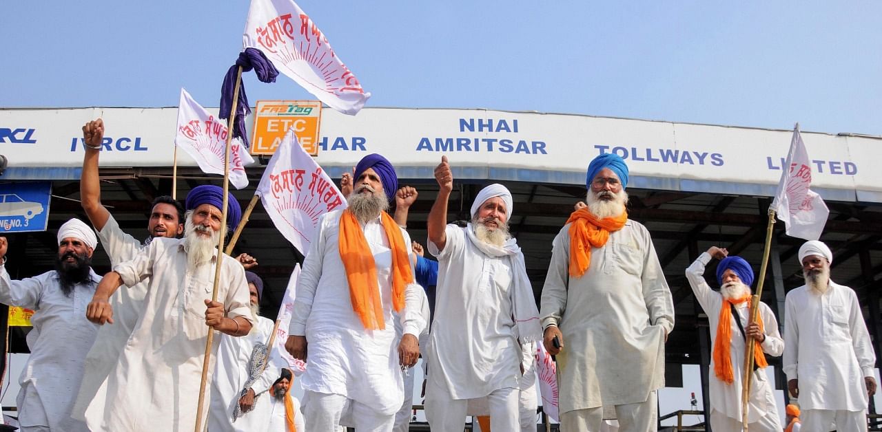 Members of various farmers organisations block toll gates on the National Highway (NH1) during a protest over the new farm reform bills, in Amritsar. Credit: PTI Photo