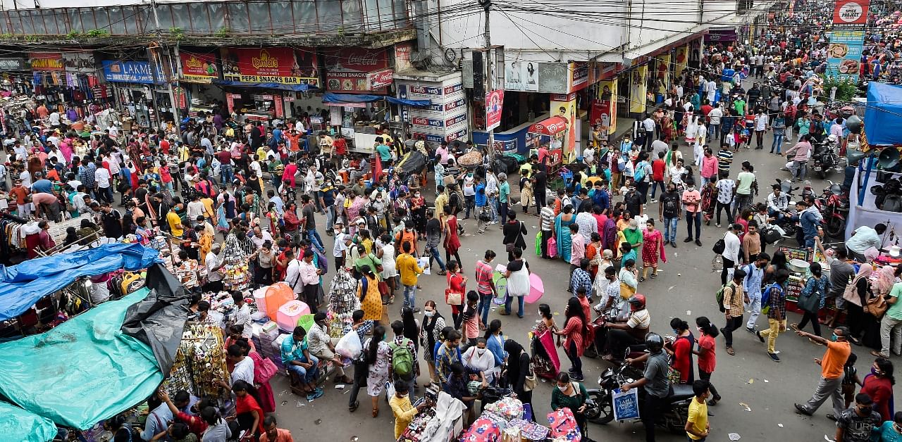 People throng a market for shopping ahead of the upcoming Durga Puja festival at New Market area amid coronavirus pandemic, in Kolkata. Credit; PTI Photo