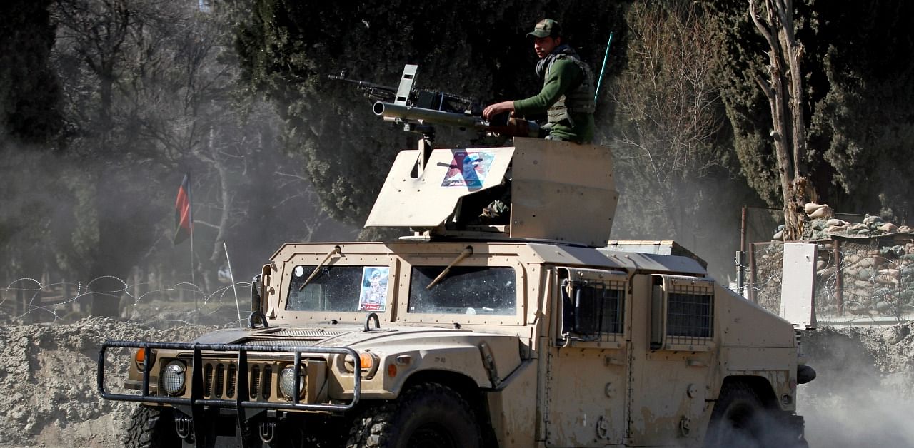 An armoured vehicle patrols near the side of an incident where two US soldiers were killed a day before in Shirzad district of Nangarhar province, Afghanistan. Credit: Reuters Photo