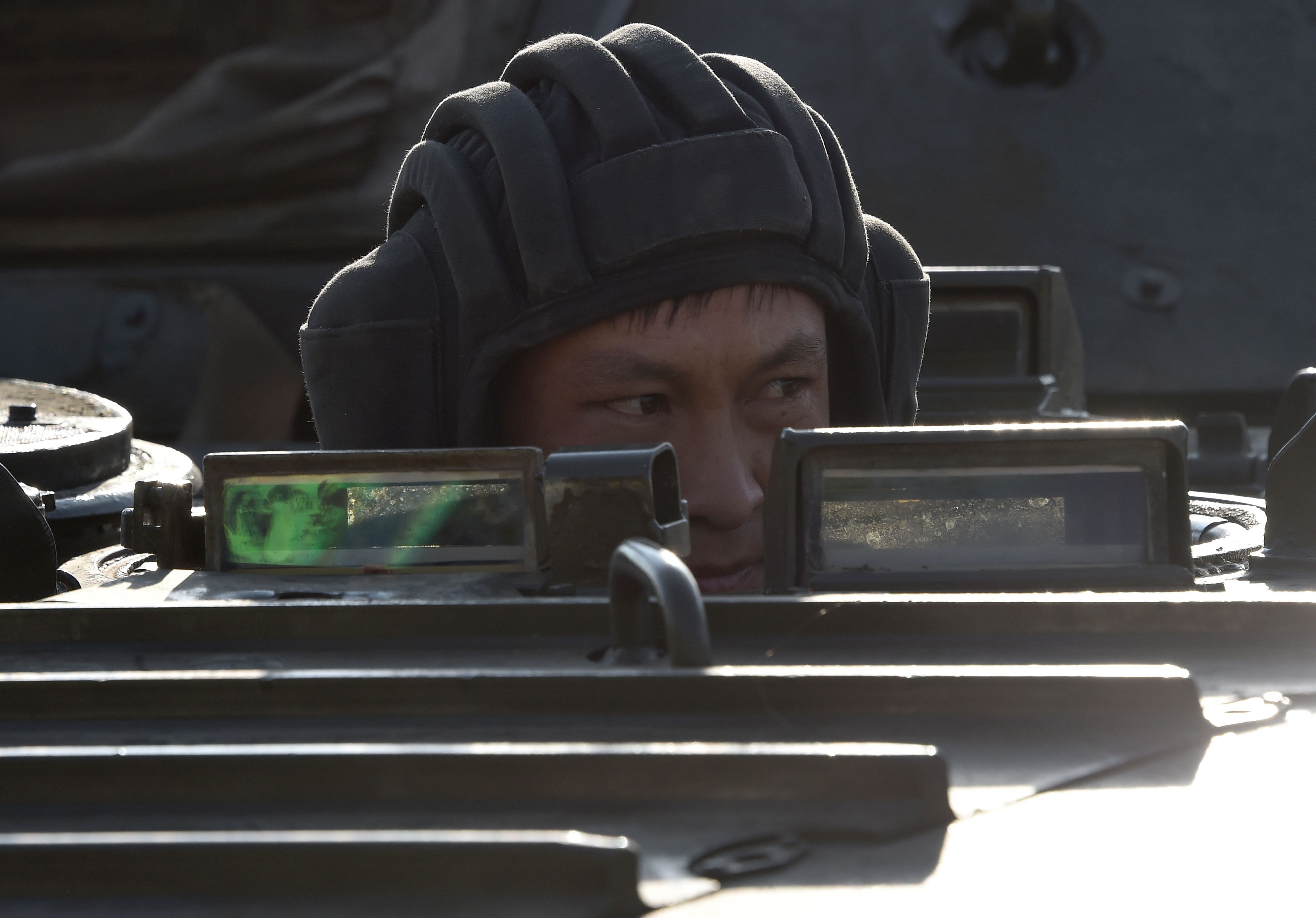 A picture taken on October 12, 2020 shows servicemen at a checkpoint set on the outskirts of Bishkek following president Jeenbekov's declaration of a 12-day state of emergency due to protests sparked by a disputed parliamentary vote. Credit: AFP Photo