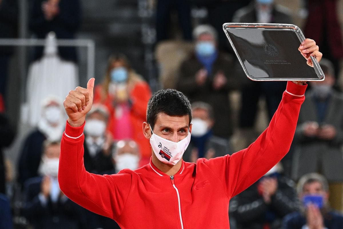 Serbia's Novak Djokovic celebrates with the trophy during the podium ceremony after the men's singles final tennis match against Spain's Rafael Nadal. Credit: AFP