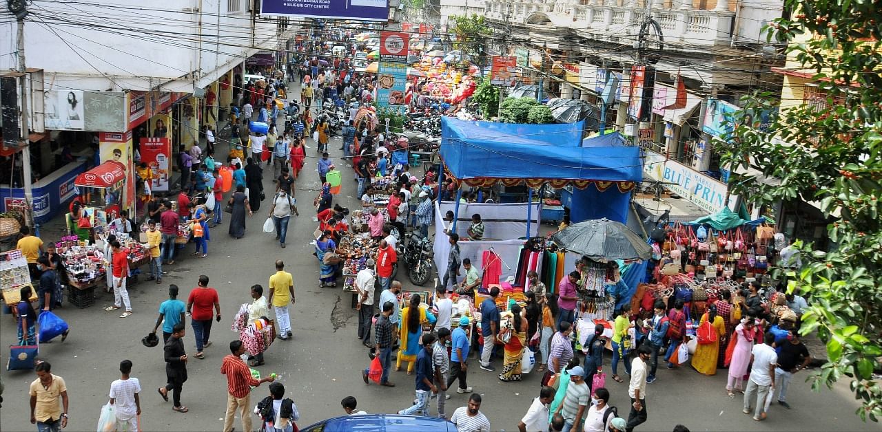 People shop ahead of the upcoming Durga Puja festival at New Market area amid coronavirus pandemic, in Kolkata. Credit: PTI Photo