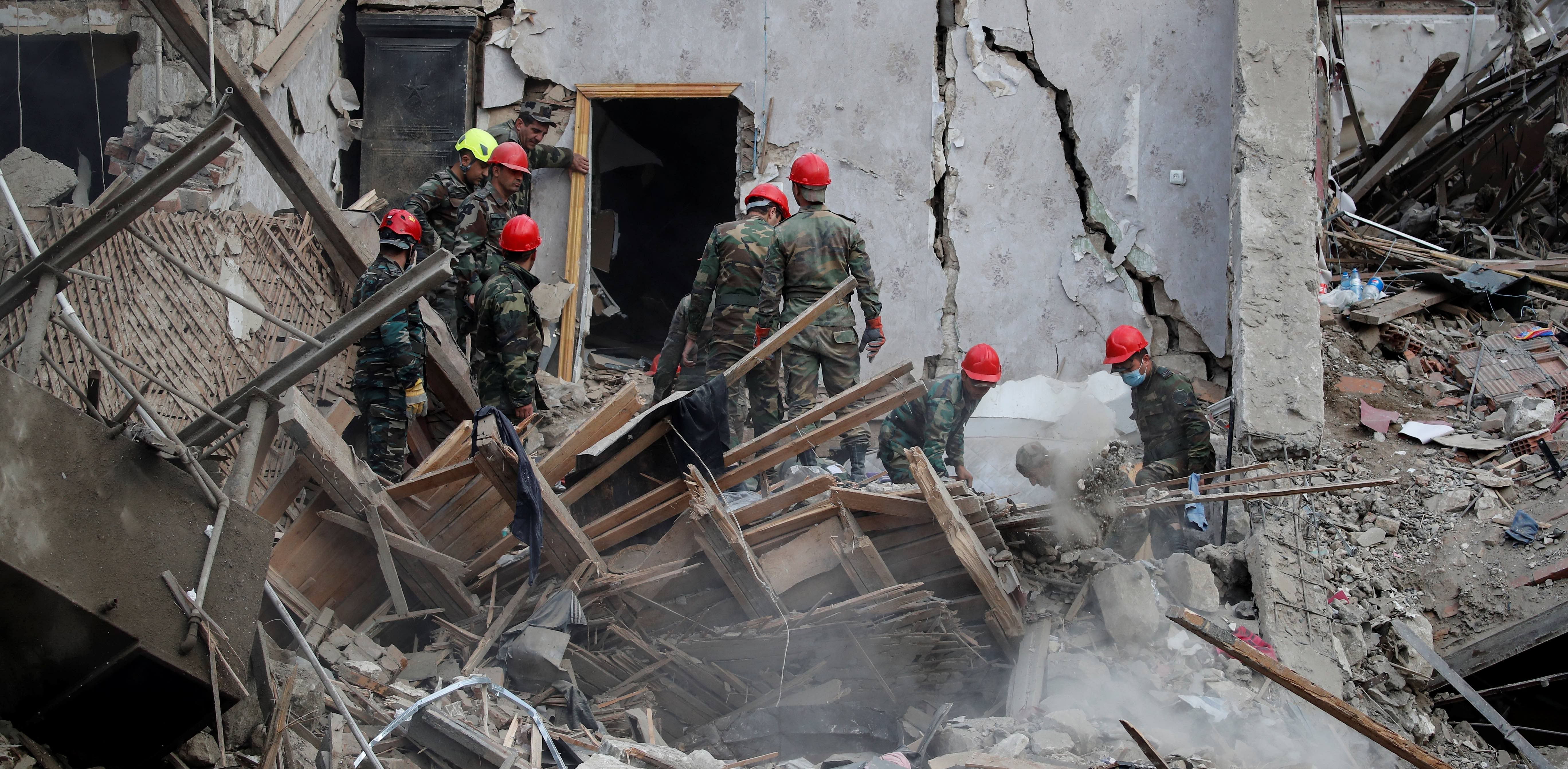Search and rescue teams work on the blast site hit by a rocket during the fighting over the breakaway region of Nagorno-Karabakh in the city of Ganja, Azerbaijan. Credit: Reuters