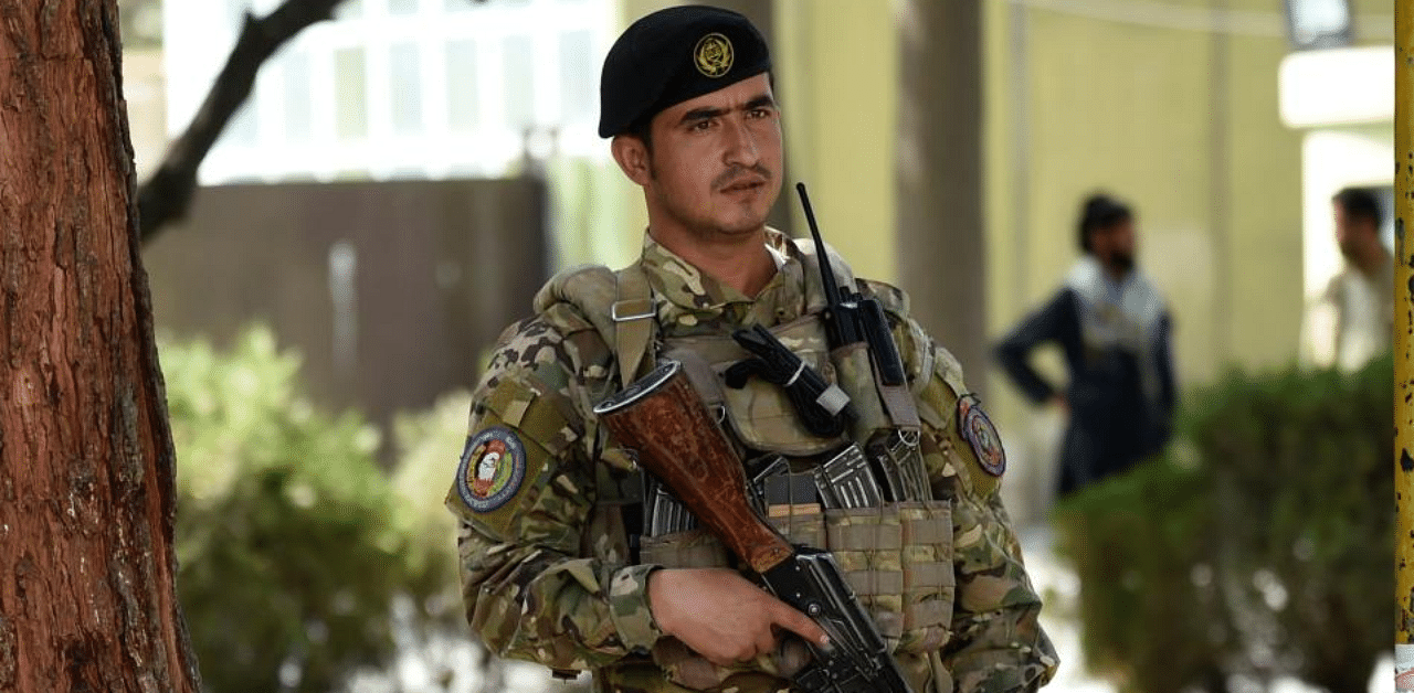 An Afghan policeman stands guard in the courtyard of the police headquarters in Kabul on October 12, 2020. Credit: AFP Photo