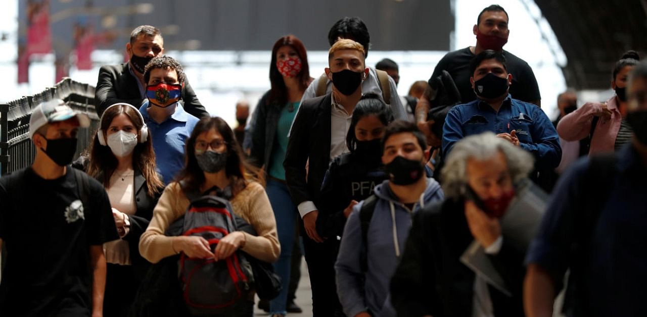 Commuters walk along a platform at Retiro train station, during the spread of the coronavirus disease, in Buenos Aires, Argentina. Credit: Reuters