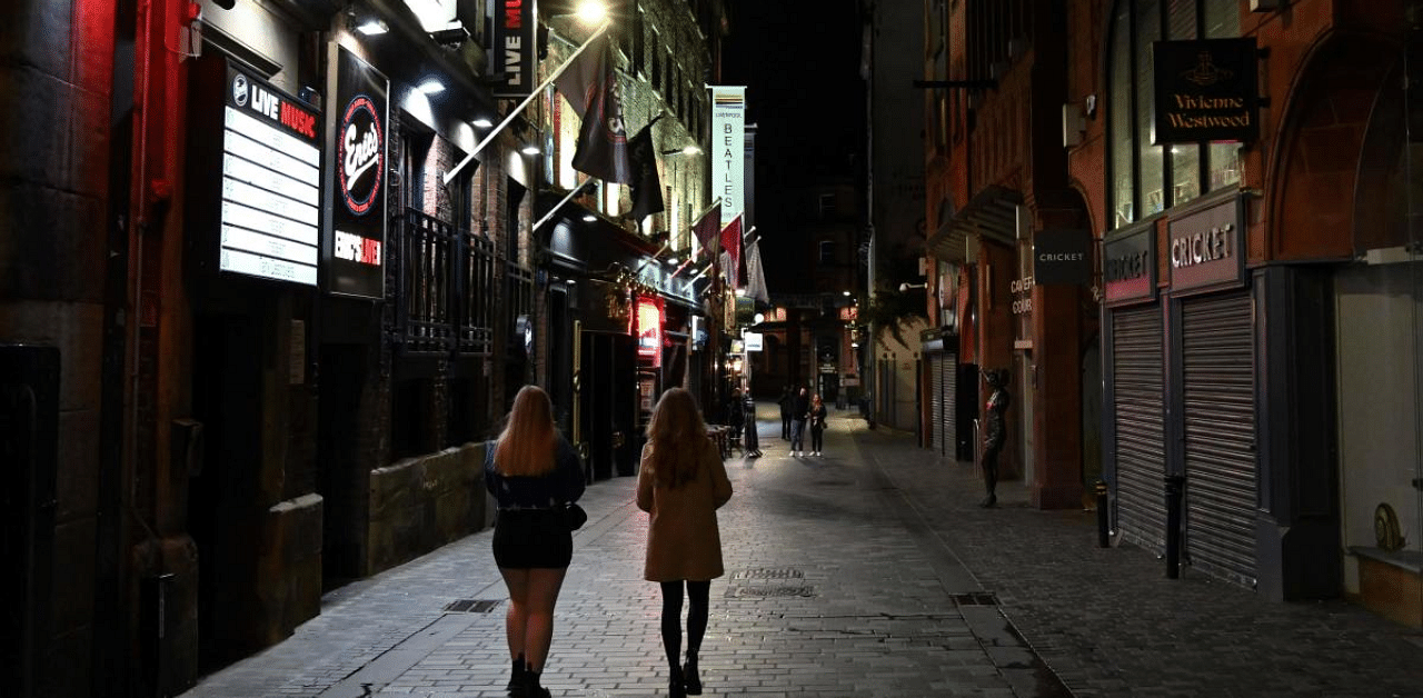 Bars open their doors on the final night in Liverpool, north west England on October 13, 2020, before new local lockdown measures are imposed to help stem a second wave of the novel coronavirus. Credit: AFP Photo