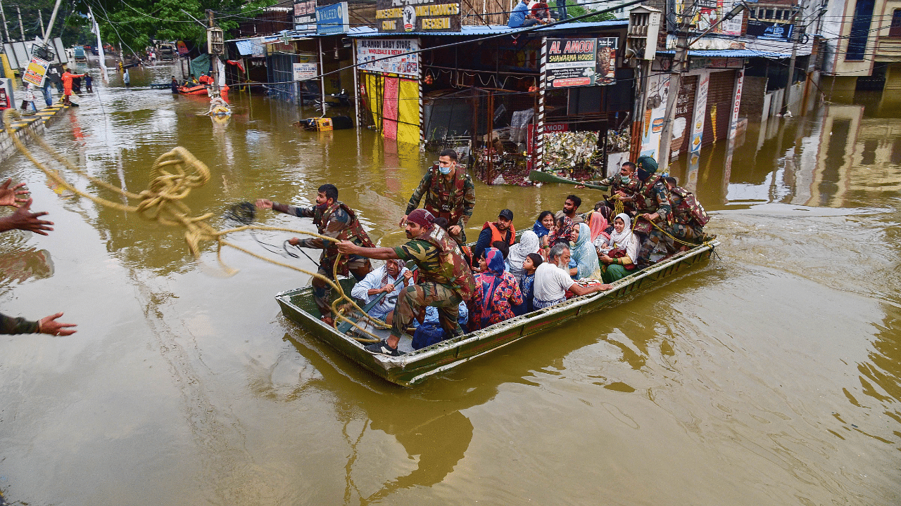 Rescue operation being carried out for locals to move them to safer places following heavy rain. Credits: PTI Photo