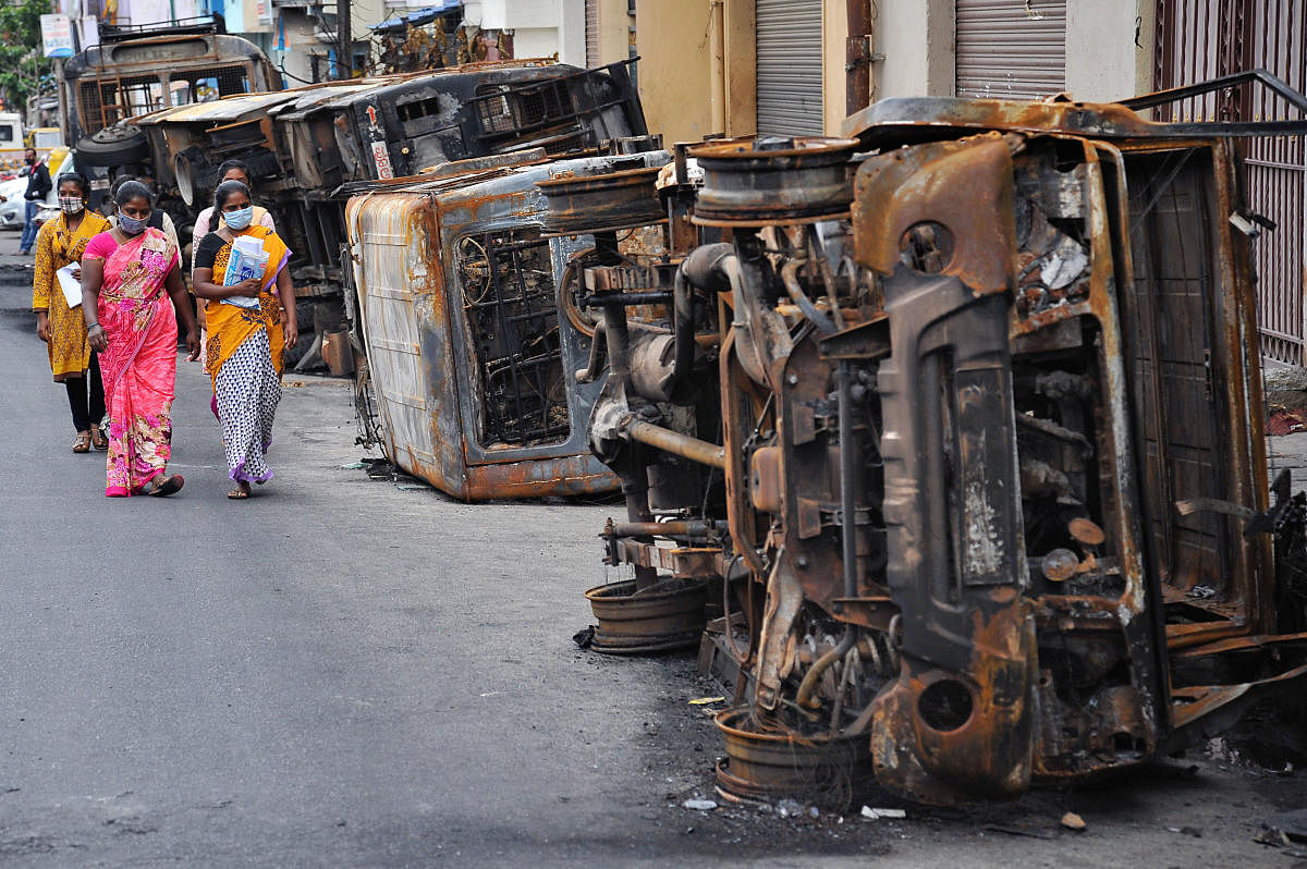 Charred vehicles in DJ Halli following the riots. DH file photo