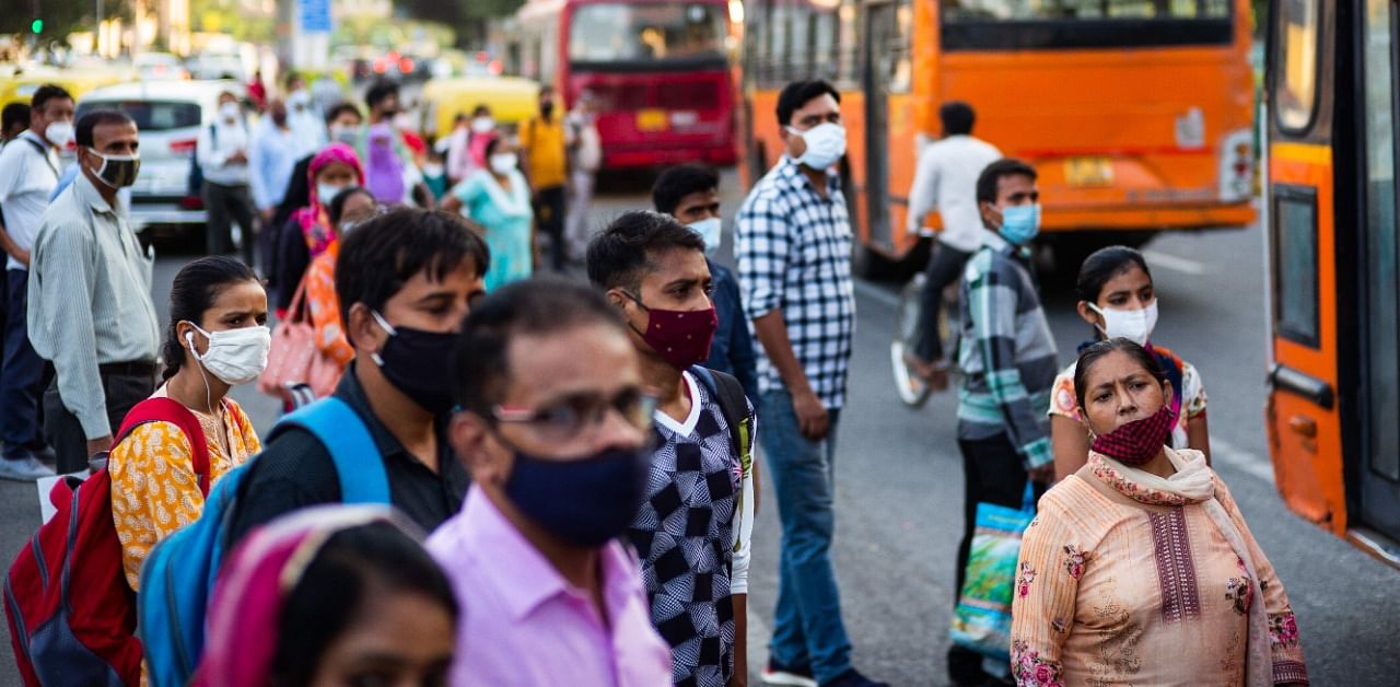 Commuters wearing facemasks as a preventative measure against the Covid-19. Credit: AFP Photo