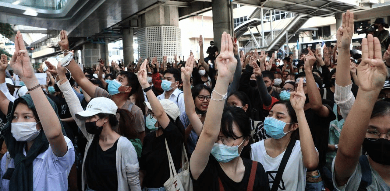Pro-democracy protesters give the three-finger salute as they gather for a rally in Bangkok on October 15, 2020, after Thailand issued an emergency decree following an anti-government demonstration the previous day. Credit: AFP Photo