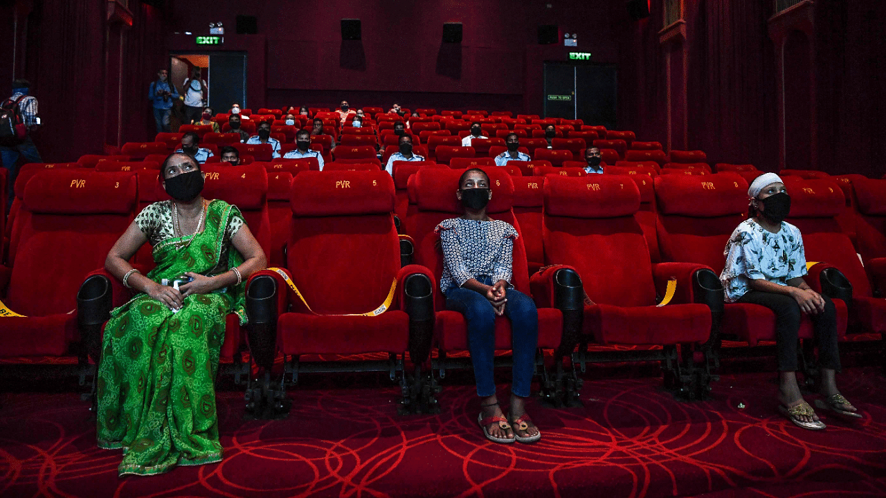 People invited as 'Covid-19 warriors' and their families to a special screening watch Bollywood movie 'Tanhaji' in a cinema in New Delhi. Credits: AFP Photo