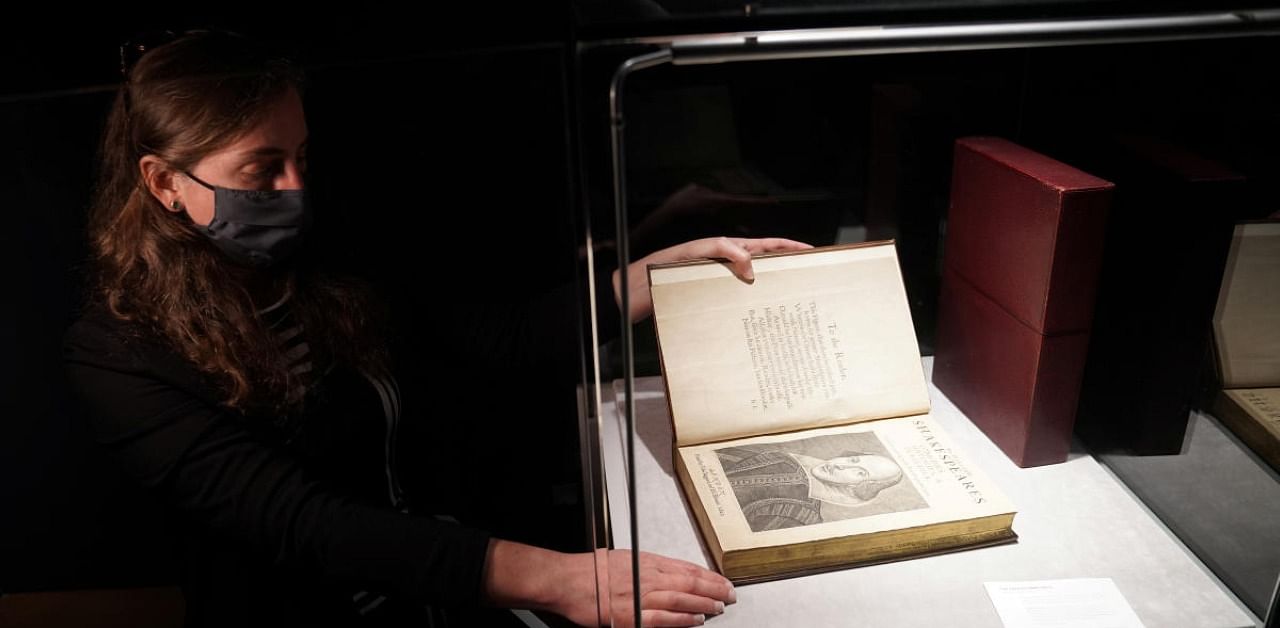 An employee of Christie's auctions holds a 1663 rare first folio of 36 Shakespeare works that was sold for a record 8.4 million dollars (9.978 million with buyers fee) is seen in the Manhattan borough of New York City, New York. Credit: Reuters