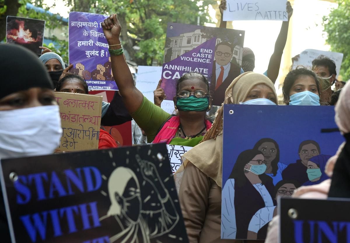 Activists hold placards and shout slogans during a protest against the death of a 19-year-old Dalit woman who was allegedly gang-raped two weeks ago in Hathras. Credit: PTI