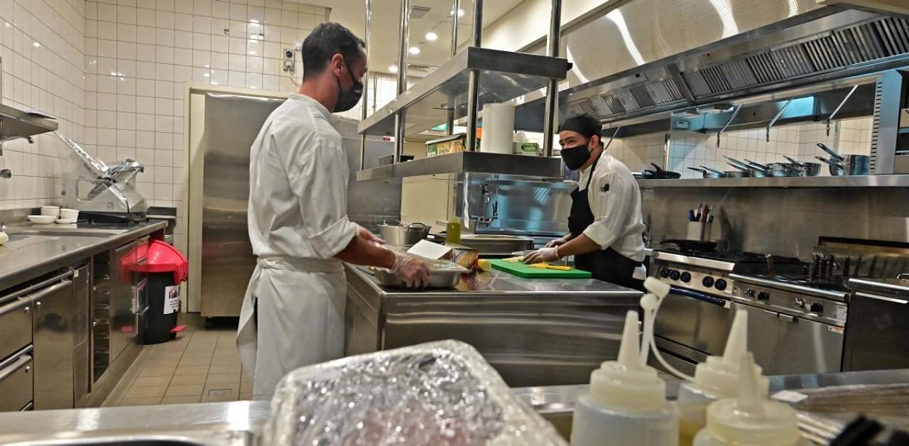 Fabien Fayolle (L), the chef at the Armani/Kaf, Dubai's first kosher restaurant, is pictured at his kitchen. Credit: AFP
