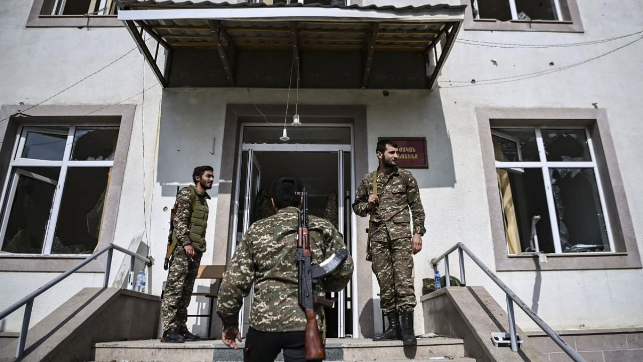 Armenian soldiers stand at the entrance of a military hospital of the Martakert region on October 15, 2020, a day after shellings during the ongoing fighting between Armenia and Azerbaijan over the disputed region. Credit: AFP.