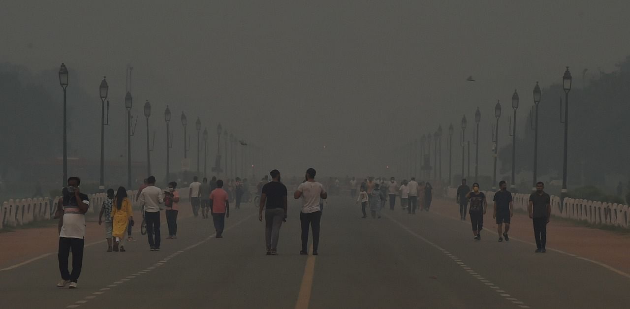 Morning walkers on the Rajpath amid hazy weather conditions, in New Delhi. Credit: PTI Photo