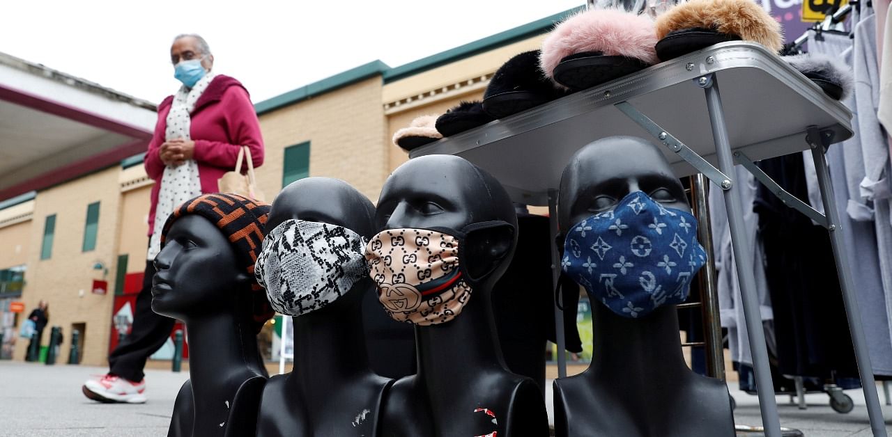 A person walks past protective face masks for sale amid the outbreak of the coronavirus disease. Credit: Reuters Photo
