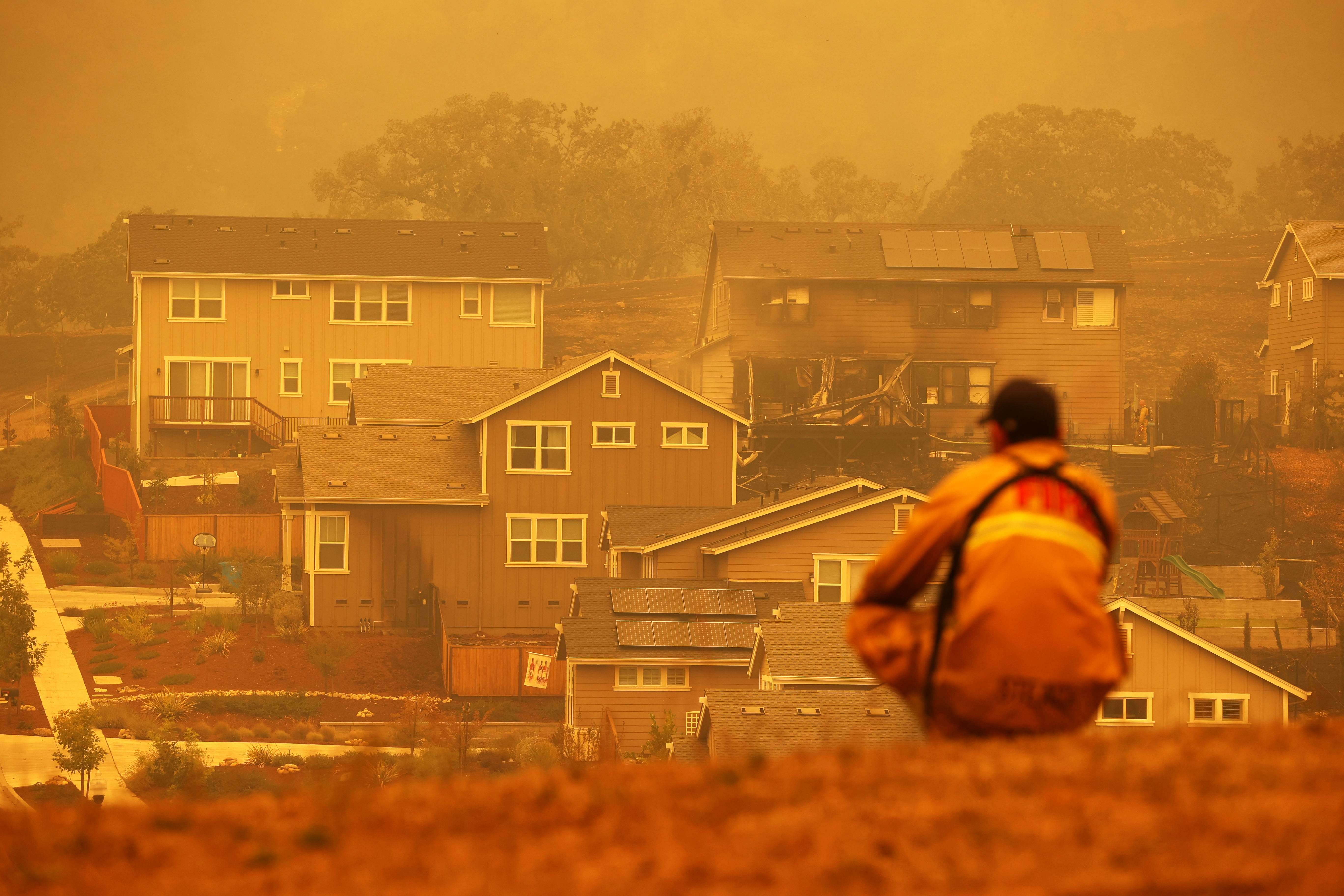 A firefighter looks towards a home that was destroyed by the Glass Incident Fire on September 28, 2020 in Santa Rosa, California. The fast-moving Glass Incident, originally called the Glass Fire, has burned over 11,000 acres in Sonoma and Napa counties. The fire is zero percent contained. Much of Northern California is under a red flag warning for high fire danger through Monday evening. Credit: Getty Images/AFP