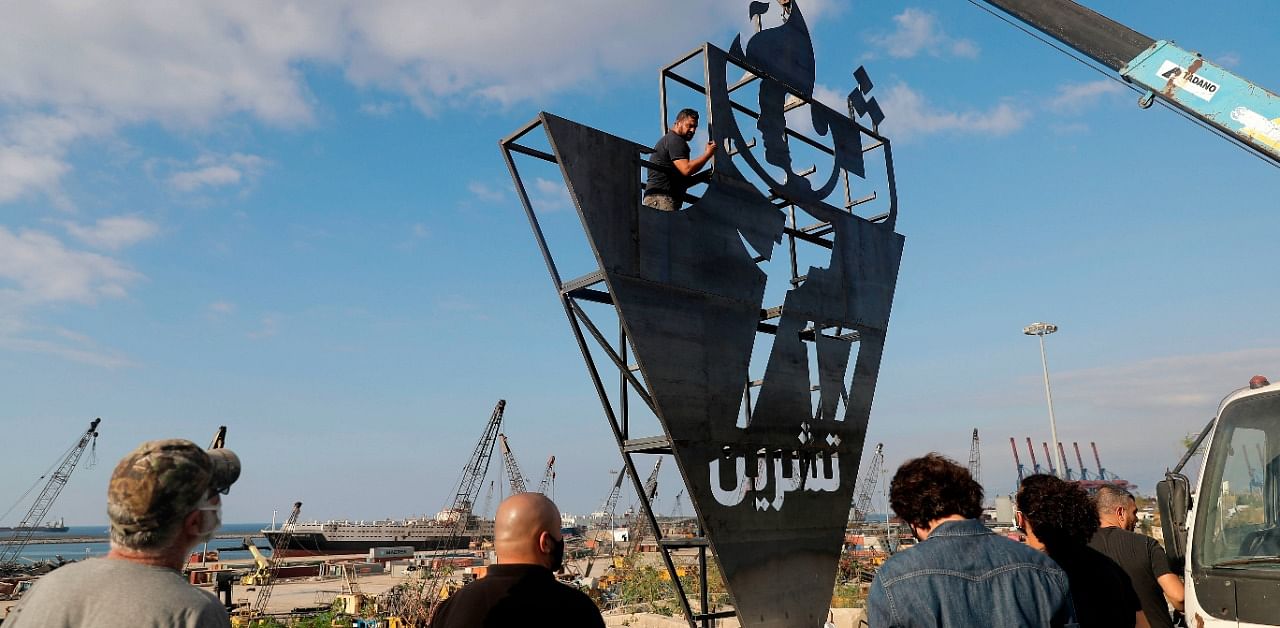 Lebanese activists erect a metalic monument on October 16, 2020, with 'October 17' written on it in Arabic, a day ahead of the one year anniversary of the beginning of a nationwide anti-government protest movement. Credit: AFP Photo