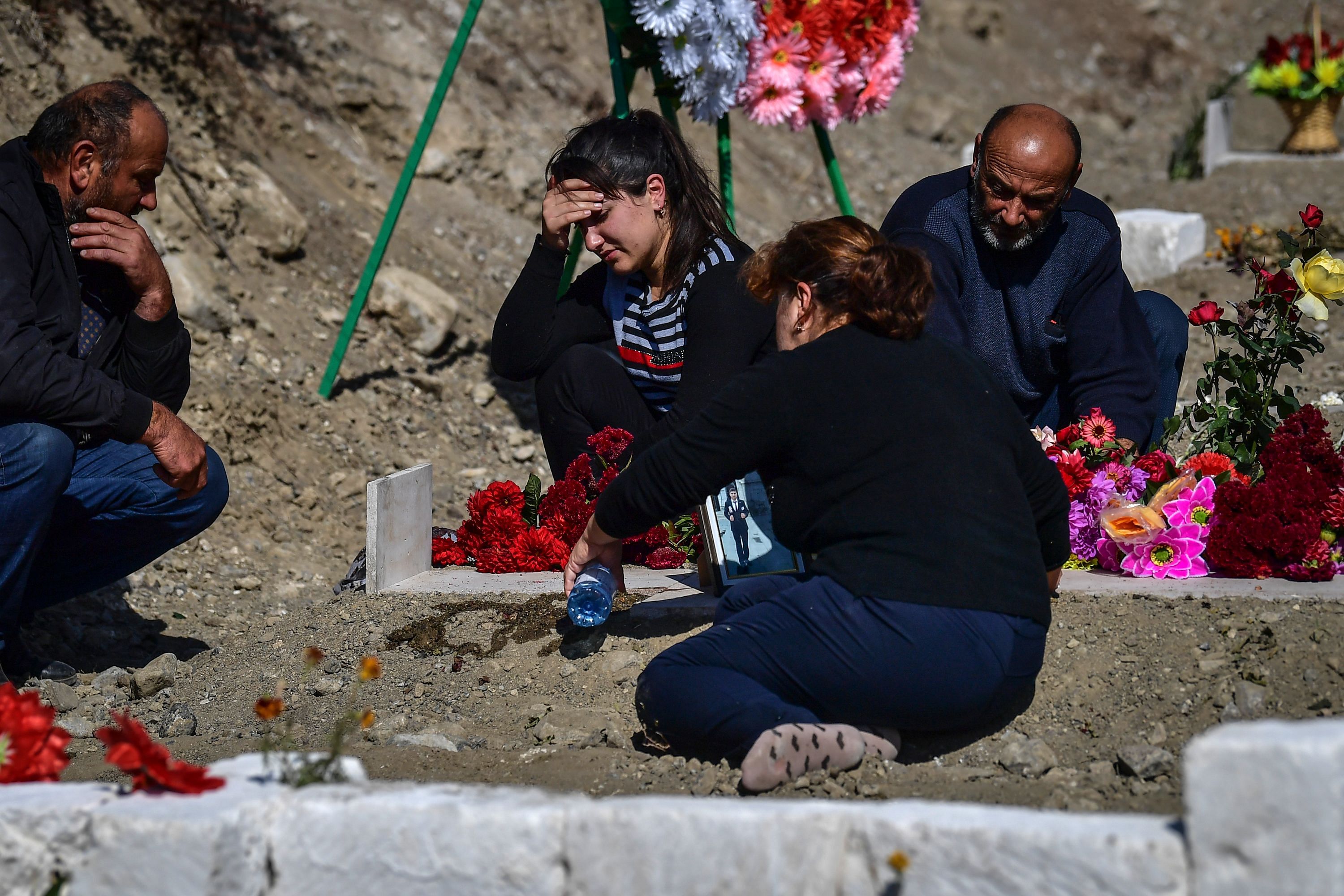 Relatives mourn by the grave of a fighter in Stepanakert during fighting over the breakaway region of Nagorno-Karabakh. Credits: AFP Photo