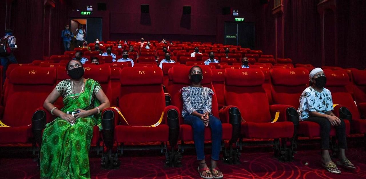 People invited as 'Covid-19 warriors' and their families to a special screening watch Bollywood movie 'Tanhaji' in a cinema in New Delhi on October 15, 2020, with some states still keeping theatres closed amid the Covid-19 coronavirus pandemic. Credit: AFP Photo