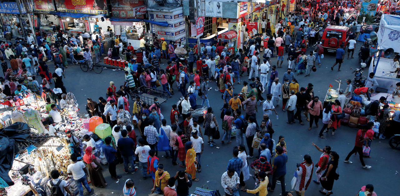 People throng a market to shop ahead of Durga Puja amidst the spread of Covid-19 in Kolkata. Credit: Reuters Photo