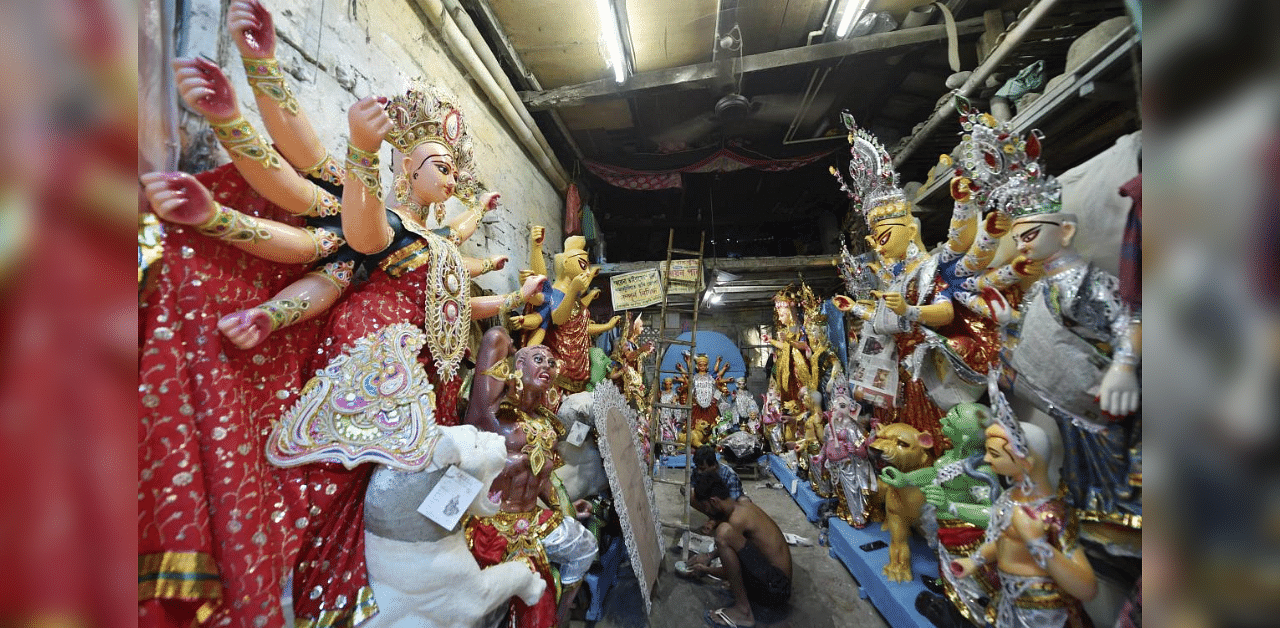 Artists give finishing touches to idols of Goddess Durga ahead of Durga Puja festival, at Kumartuli in Kolkata, Wednesday, Oct. 14, 2020. Credit: PTI Photo