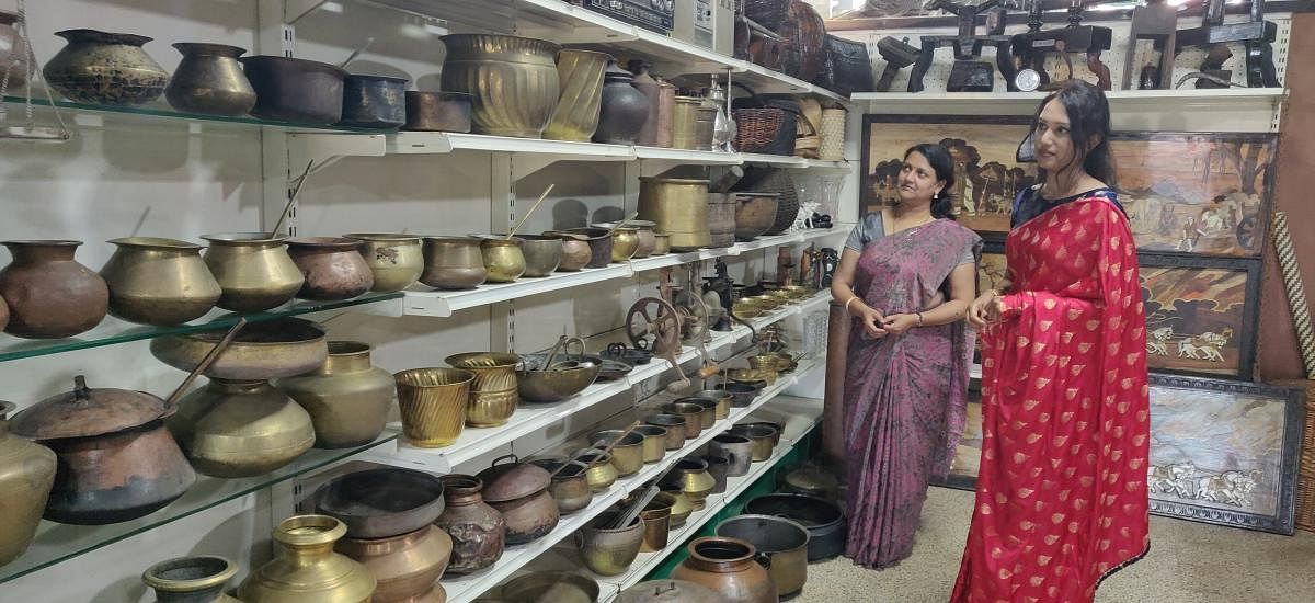 Visitors look at the vast range of antique utensils and other items exhibited from the collection of Ponnacchana Madhu in Madikeri on Friday.