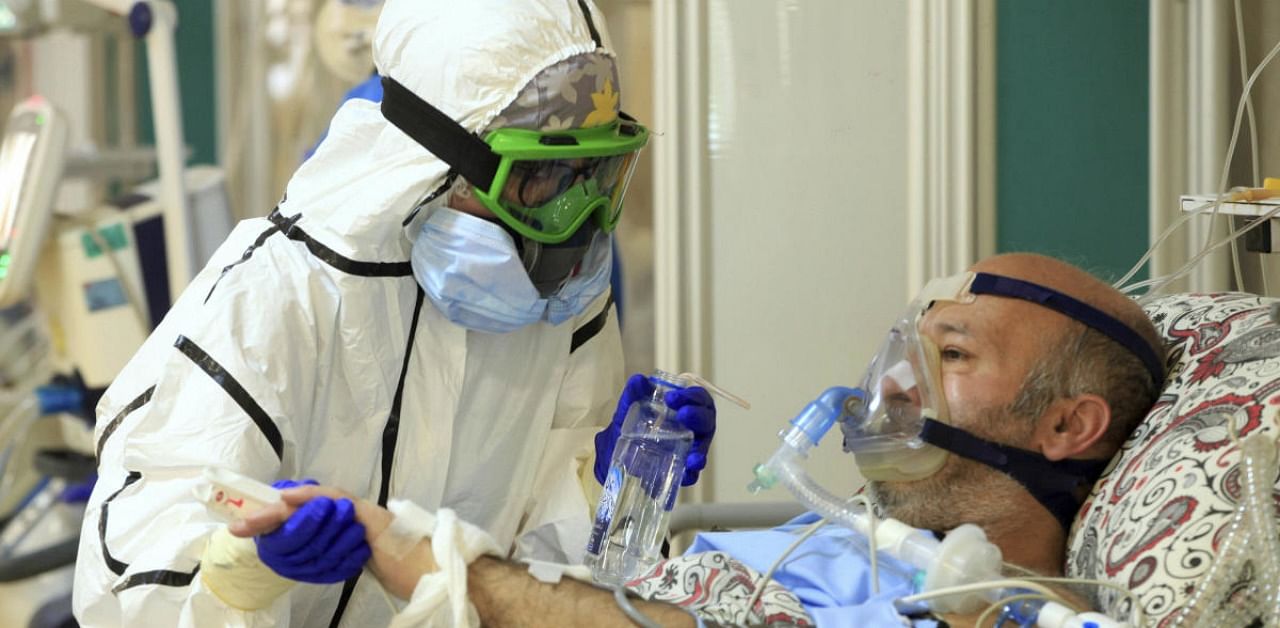 In this photo provided by the Iranian Health Ministry, a medic tends to a Covid-19 patient at the Shohadaye Tajrish Hospital in Tehran. Credit: AP/PTI.