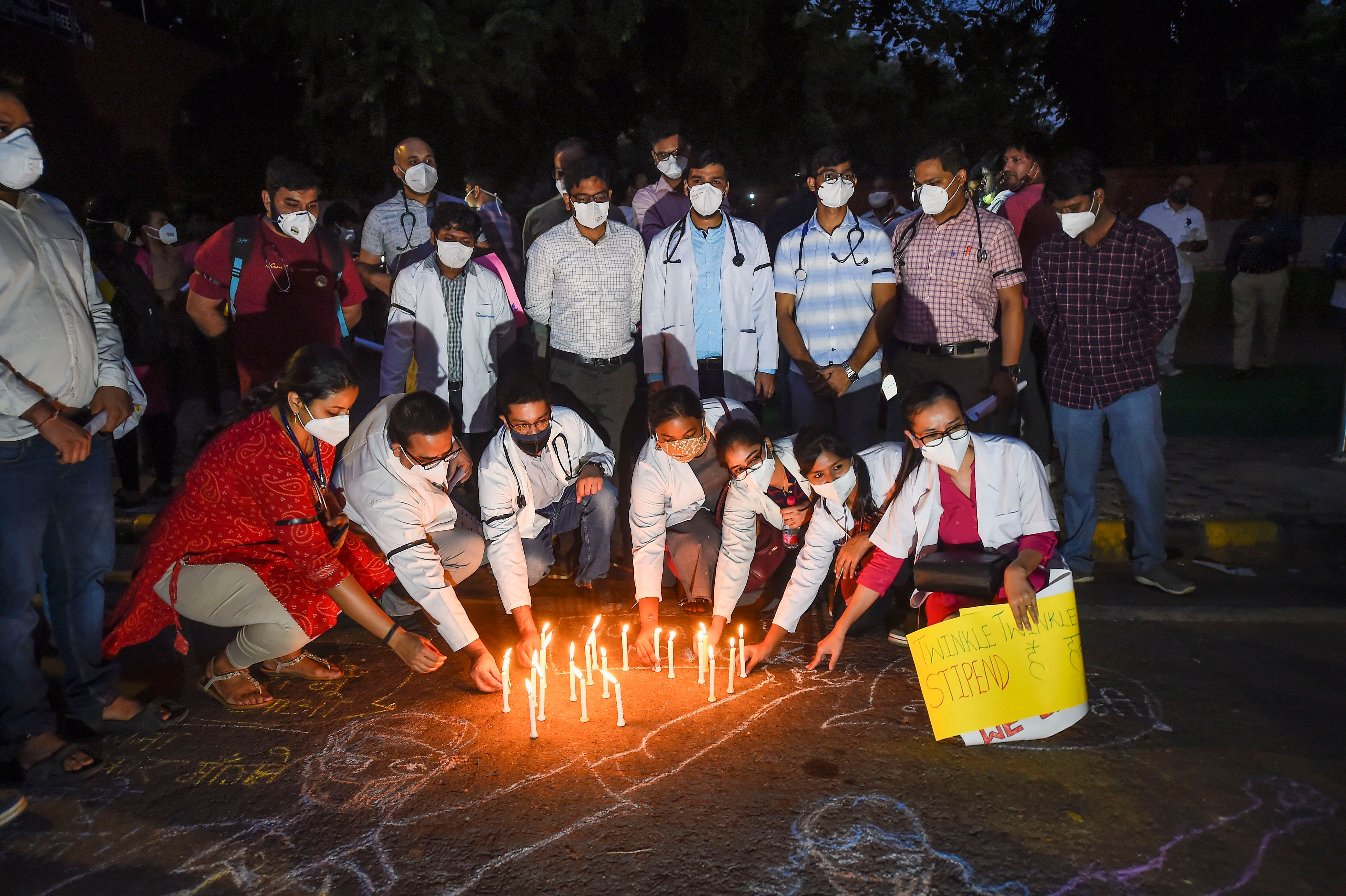 Doctors light candles during a protest against North Delhi Municipal Corporation, demanding to clear their outstanding remuneration, at Jantar Mantar in New Delhi, Friday, Oct. 16, 2020. Credit: PTI Photo