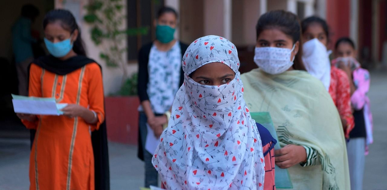 Students wearing facemasks as a preventive measure against the Covid-19. Credit: AFP Photo