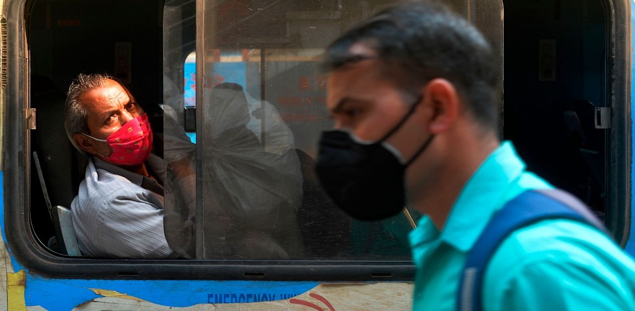 Train passengers wearing facemasks as a preventative measure against the Covid-19. Credit: AFP Photo