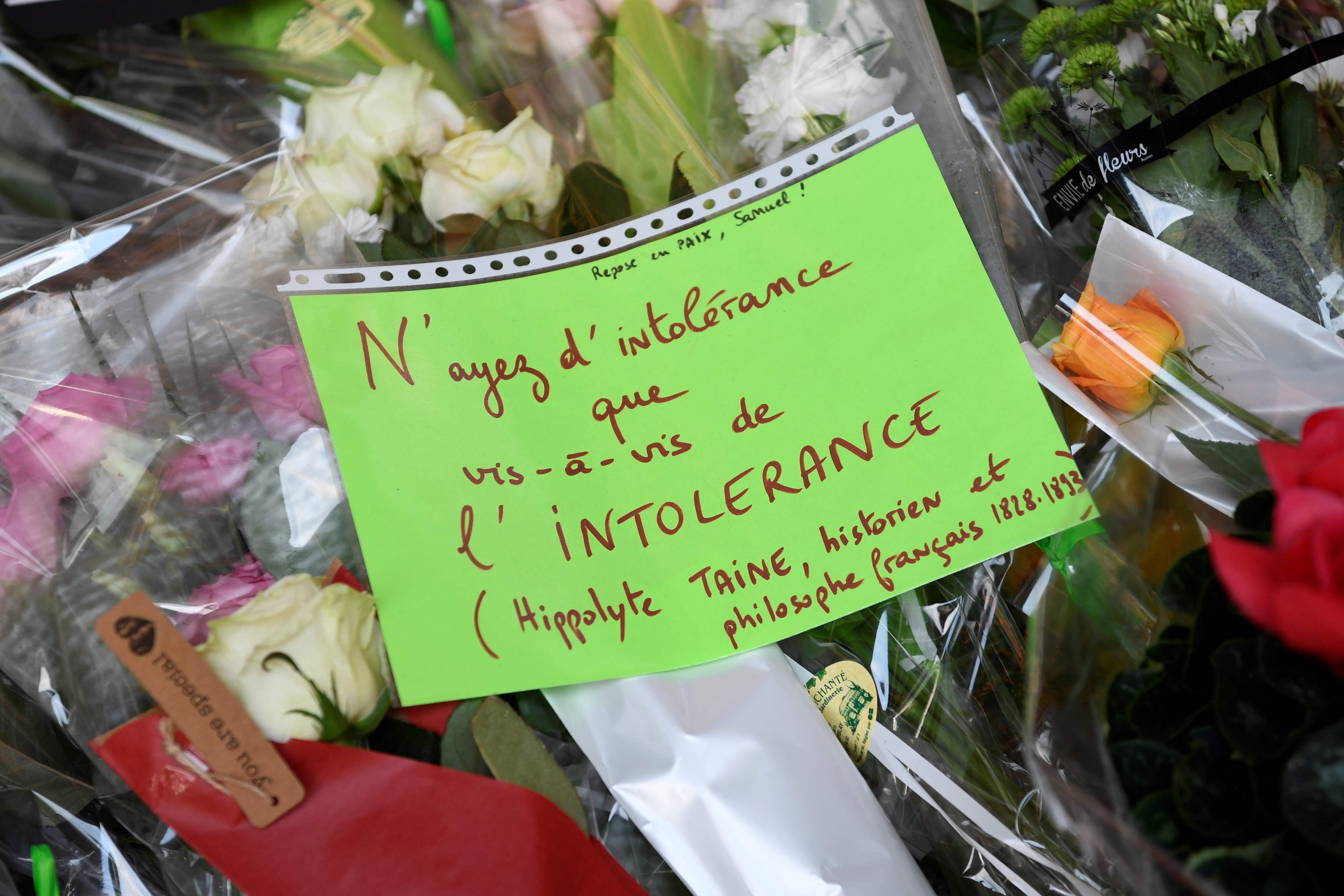 Placard reading 'Have intolerance only for intolerance' at the entrance of a middle school in Conflans-Sainte-Honorine, 30kms northwest of Paris, on October 17, 2020, after a teacher was decapitated by an attacker who has been shot dead by policemen. Credit: AFP Photo