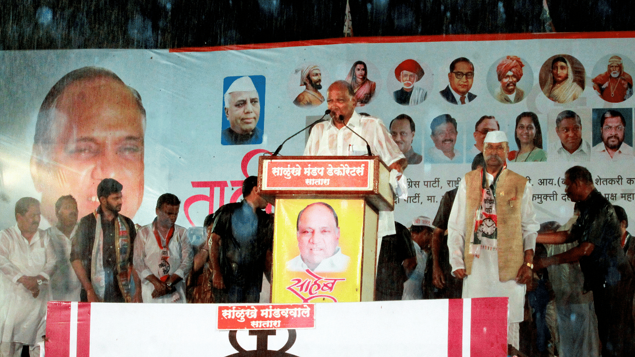 Nationalist Congress Party (NCP) President Sharad Pawar addresses a public meeting ahead of the Assembly elections during rain. Credits: PTI File Photo