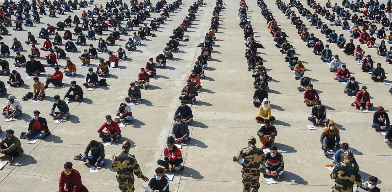 Aspirants appear in an entrance exam, conducted by Border Security Force (BSF) during a recruitment rally, at Humhama on the outskirts of Srinagar, Sunday, Oct. 18, 2020. BSF held the second round of recruitment in the form of written test at its nine centers in Jammu & Kashmir and Ladakh. Credit: PTI Photo