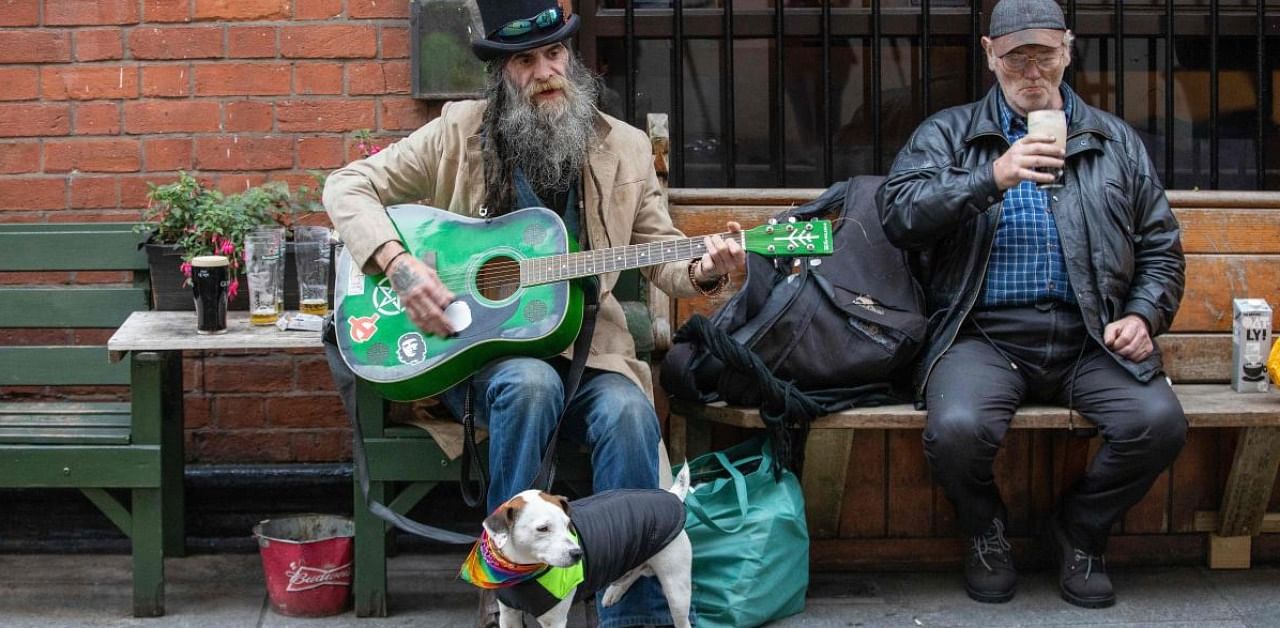 Patrons enjoy a drink at Bittles bar in Belfast on October 16, 2020, as Northern Ireland imposes tighter coronavirus restrictions on the hospitality sector amid an uptick in Covid-19 cases. Credit: AFP.