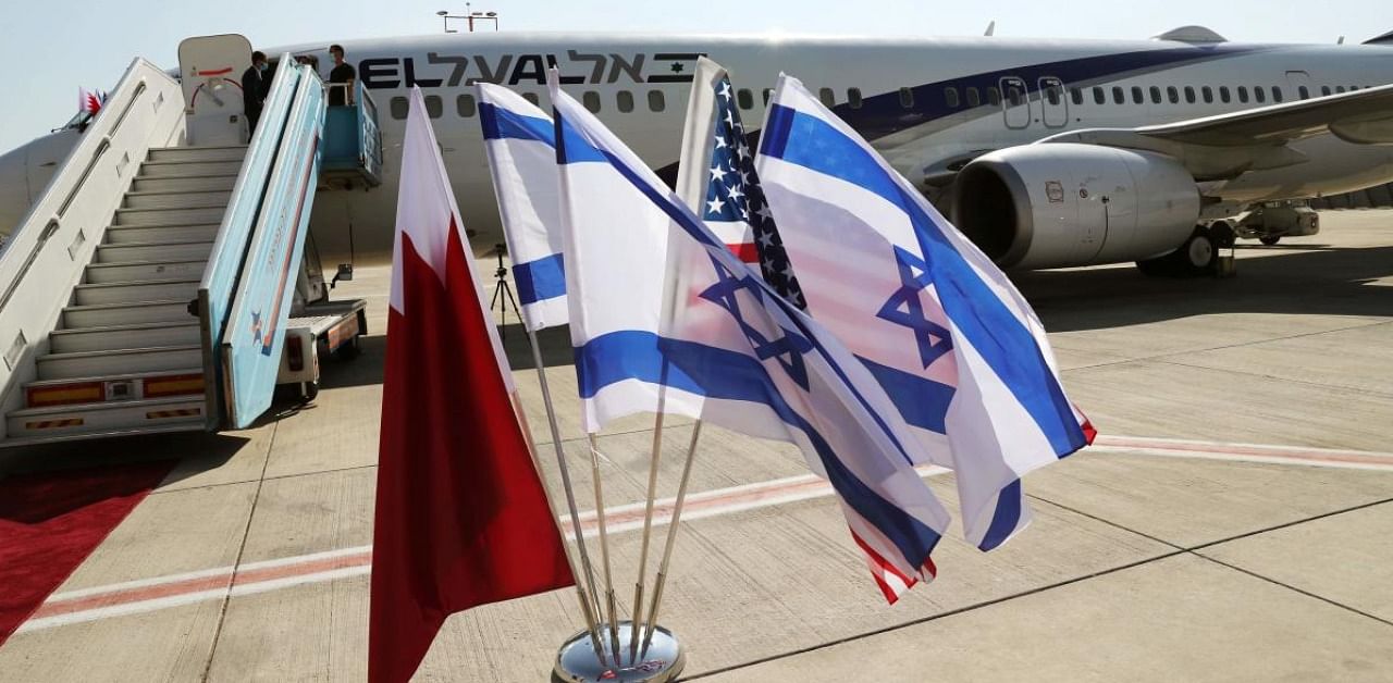 The Bahraini, Israeli and US flags are picture in front of El Al plane ahead of the flight to Bahrain's capital Manama at Israel's Ben Gurion Airport near Tel Aviv. Credit: AFP.