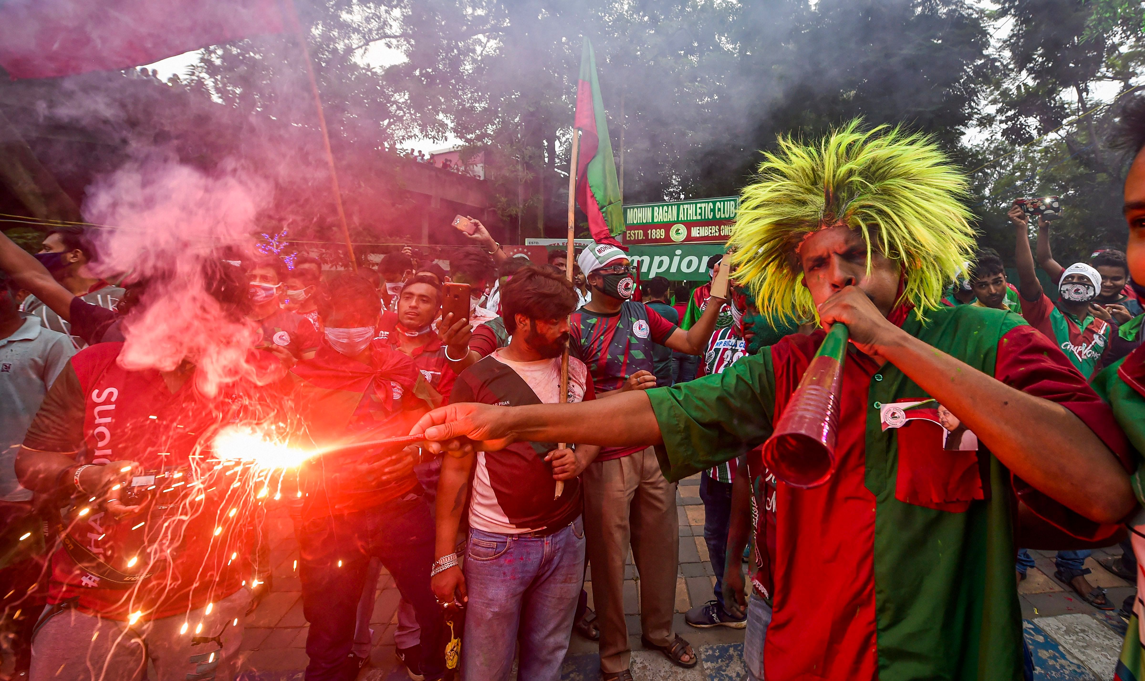 Supporters of Mohun Bagan A.C. celebrate during a victory parade after the club won I-League championship, in Kolkata, Sunday, Oct. 18, 2020. Credit: PTI Photo