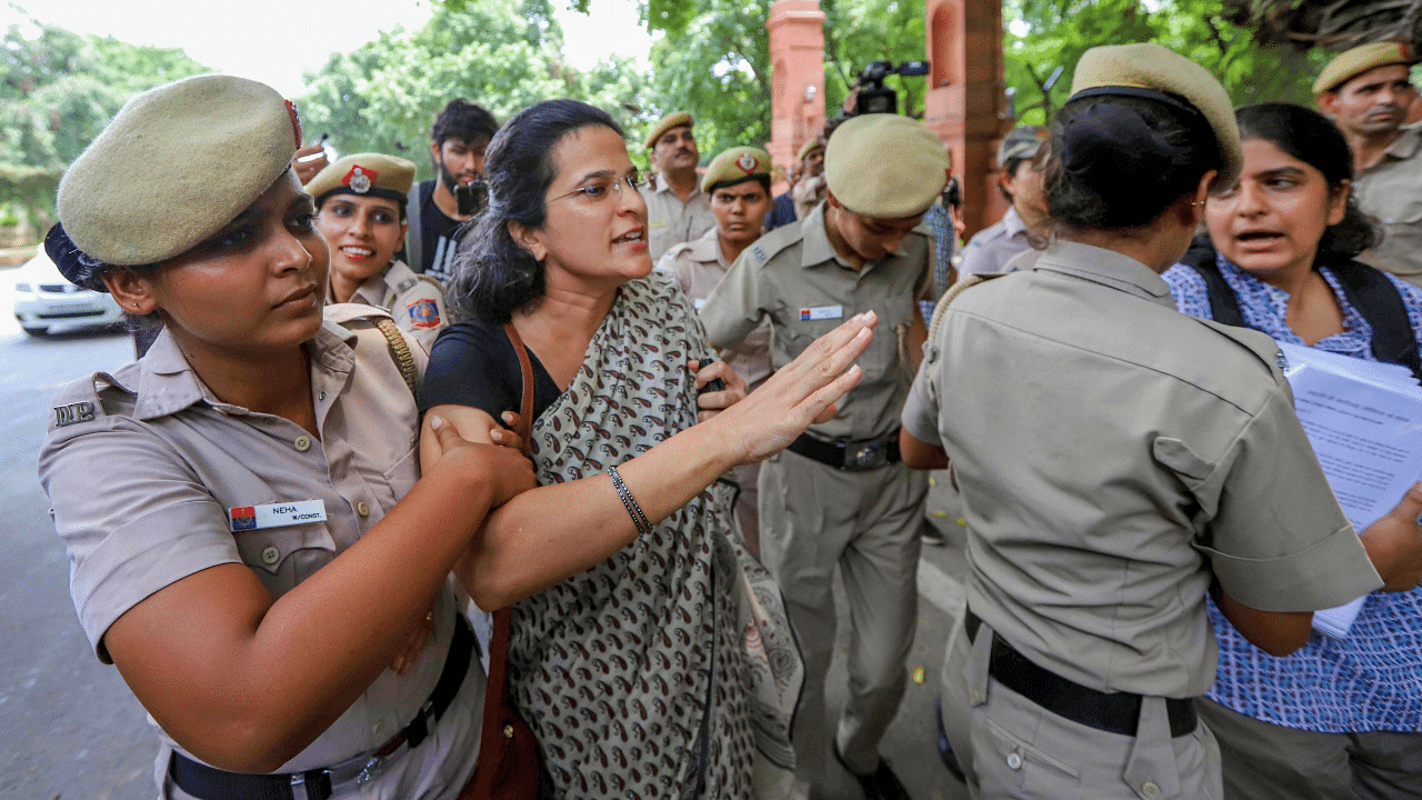 Activist Anjali Bhardwaj with others being detained by the Delhi Police. Credits: PTI File Photo