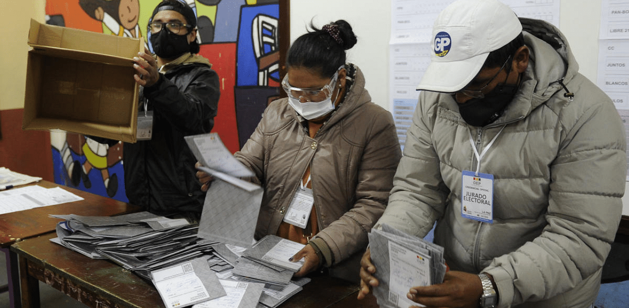 Electoral employees prepare to count votes at a polling station during general elections in La Paz. Credit: AFP Photo